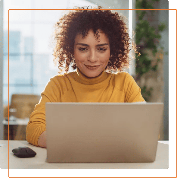 Photo of a professional woman working on a laptop.