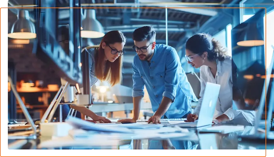 A diverse group of professionals collaborates around a modern workspace, analyzing blueprints and discussing ideas amidst sleek technology.